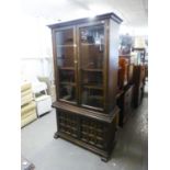 A MODERN DARK OAK DISPLAY CABINET OVER CUPBOARD, THE DOUBLE GLAZED DOORS ENCLOSING TWO SHELVES,