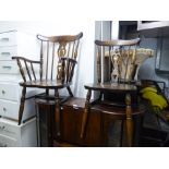 SET OF SIX HARDWOOD COMB BACKED WINDSOR DINING CHAIRS WITH PANEL SEATS, INCLUDING THE CARVER'S