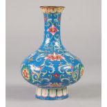 A CHINESE QING DYNASTY CANTON ENAMEL VASE of compressed baluster form rising from a spreading stem