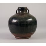 AN AGED PROBABLY CHINESE STONEWARE GLOBULAR VASE with short waisted neck issuing loop handles, the
