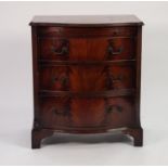 GEORGIAN STYLE FIGURED MAHOGANY SERPENTINE FRONTED BACHELOR’S CHEST OF DRAWERS, the moulded top