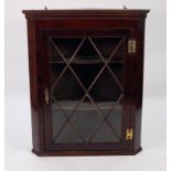 ANTIQUE FLAT FRONTED GLAZED MAHOGANY CORNER CUPBOARD, with exposed brass butterfly hinges, fancy