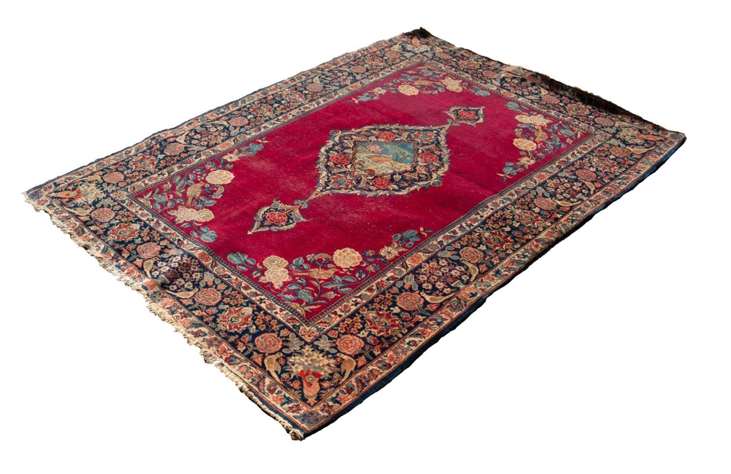 KIRMAN PERSIAN RUG, the large lozenge shaped medallion with pendants and decorated in a central