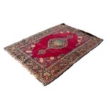 KIRMAN PERSIAN RUG, the large lozenge shaped medallion with pendants and decorated in a central