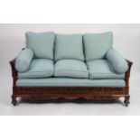 EARLY TWENTIETH CENTURY CARVED MAHOGANY AND SINGLE CANED BERGERE SETTEE, the moulded flat top rail