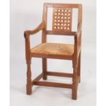 ROBERT ‘MOUSEMAN’ THOMPSON OAK CARVER ARMCHAIR, the square back with carved lattice work panel,