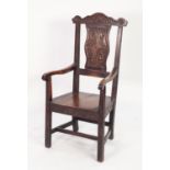 EIGHTEENTH CENTURY CARVED OAK ARMCHAIR, the moulded top rail above a shaped splat carved with scroll