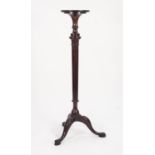 EARLY TWENTIETH CENTURY CARVED MAHOGANY TORCHERE, the moulded circular top above a part fluted and