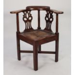 GEORGE III ‘COUNTRY CHIPPENDALE’ MAHOGANY CORNER ARMCHAIR, the shaped, flat arms surmounted by a