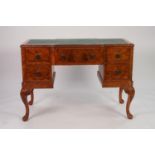 GOOD QUALITY MID TWENTIETH CENTURY CARVED AND FIGURED WALNUT KNEEHOLE WRITING TABLE IN THE QUEEN ANN
