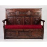 PROBABLY FLEMISH, ANTIQUE AND LATER COMPOSITE CARVED OAK SETTLE, the back with seven fielded panels,