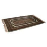 PAKISTAN TURKOMAN DESIGN PRAYER RUG, the light brown and black central panel with a chain of sixteen