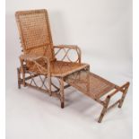 EARLY TWENTIETH CENTURY CANE WORK RECLINING STEAMER TYPE CHAIR WITH PULL-OUT FOOT REST, the back