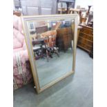 A LARGE, OBLONG BEVELLED EDGE WALL MIRROR IN FLUTED GILT FRAME, 3'9" WIDE