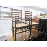 A SET OF SIX OAK LADDER BACK DINING CHAIRS WITH RUSH SEATS (4 +2)