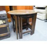 A WALNUT OVAL COFFEE TABLE ON STRAIGHT LEGS AND A NEST OF TWO OAK COFFEE TABLES (3)