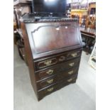 REPRODUCTION BUREAU WITH RAISED SHAPED BACK OVER SLOPE FRONT HAVING FOUR GRADUATED DRAWERS