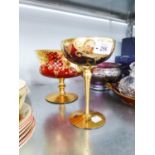 BOHEMIA RED GLASS BOWL ON STAND, WITH ELABORATE GILT AND FLORAL DECORATION AND A SIMILAR GLASS (2)