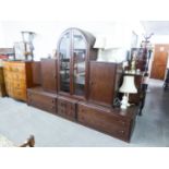 A GOOD QUALITY 'HULSTA' DARK OAK LOUNGE UNIT, THE UPPER SECTION HAVING CENTRAL ARCH GLAZED DOORS,
