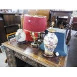 TWO LARGE ORIENTAL PORCELAIN VASE TABLE LAMPS ON HARDWOOD STANDS AND THE FABRIC SHADES AND A BRASS