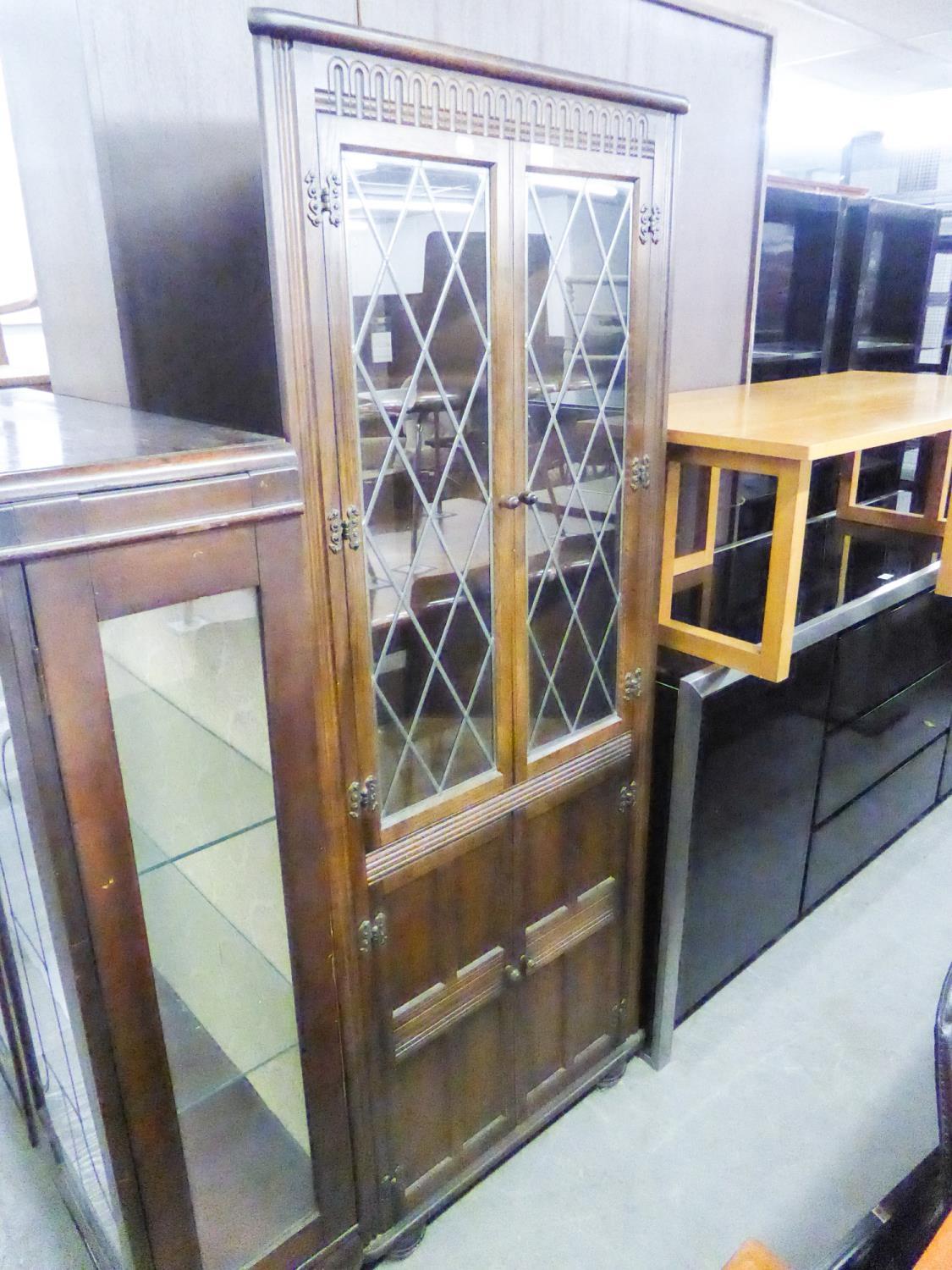 JACOBEAN STYLE CARVED OAK DOUBLE CORNER CUPBOARD, WITH PAIR OF LEAD LIGHT DOORS OVER A PAIR OF PANEL