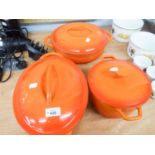 THREE ORANGE CAST IRON CASSEROLE POTS ALL WITH LIDS