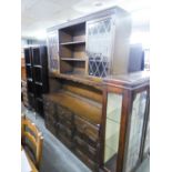 JACOBEAN STYLE CARVED OAK WELSH DRESSER, THE RAISED PLATE RACK FLANKED BY TWO LEAD LIGHT CUPBOARD