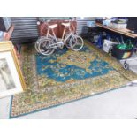 A bordered Axminster carpet of Persian design on a blue field, 10’6” x 9’