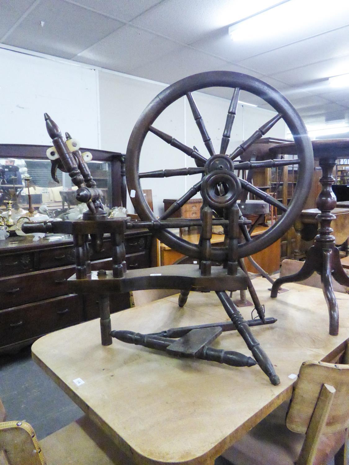 AN ANTIQUE LARGE SPINNING WHEEL