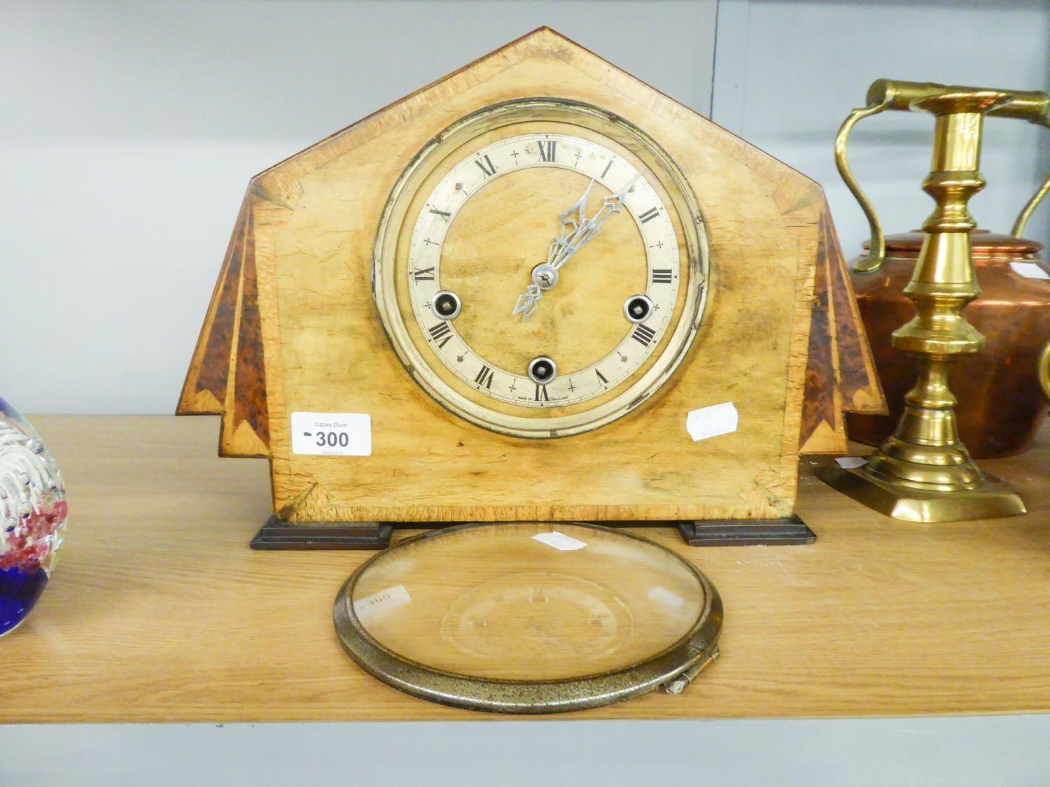 A WALNUTWOOD ART DECO MANTEL CLOCK, WITH WHITE CHAPTER RING, BLACK ROMAN NUMERALS (LACKS GLASS)