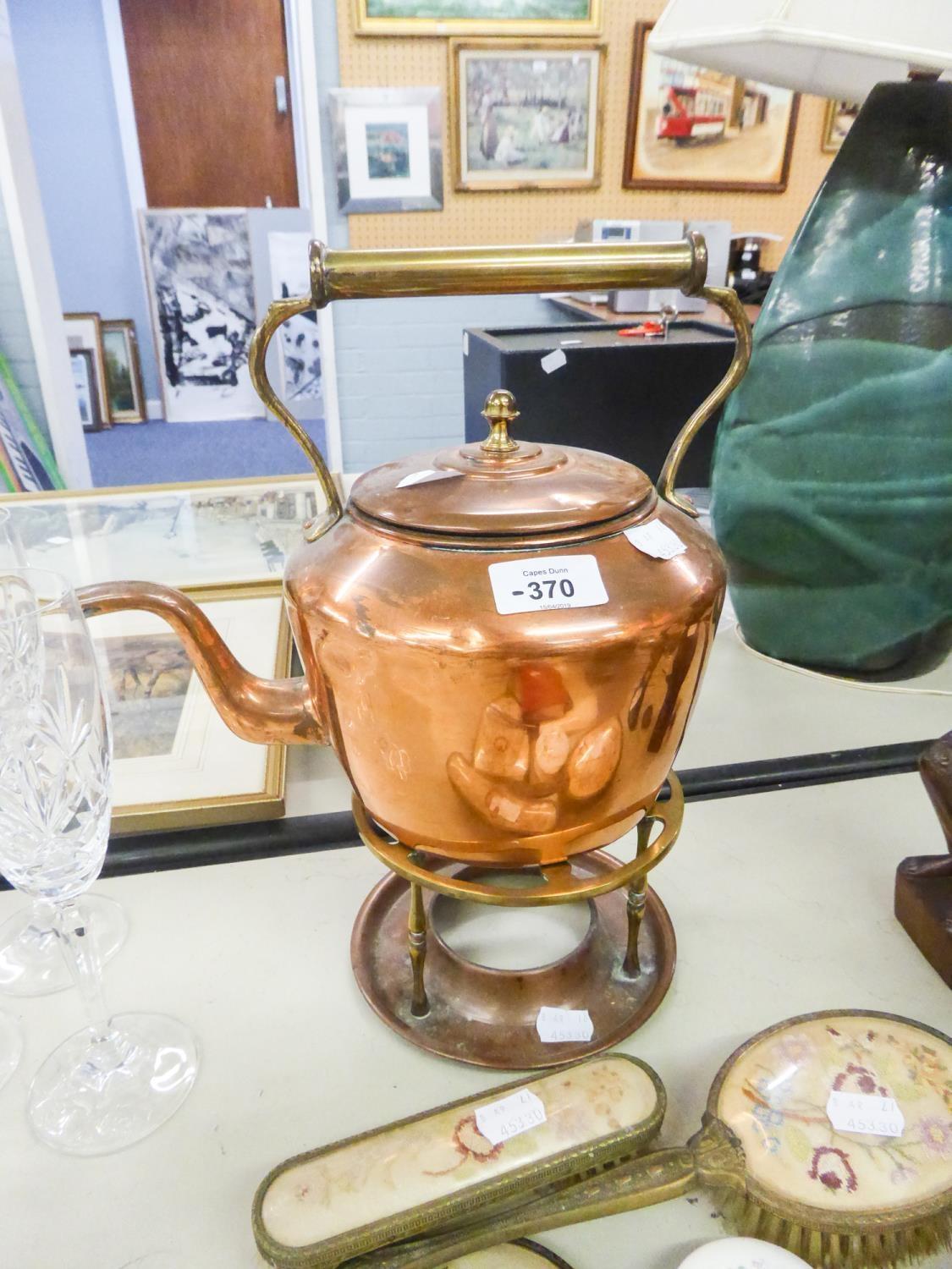 AN ANTIQUE COPPER KETTLE ON STAND