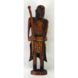 CRUDELY CARVED AFRICAN SOFTWOOD FIGURE, modelled as a standing warrior holding a spear and