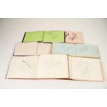 SIX SMALL AUTOGRAPH BOOKS containing numerous entertainer's autographs including Chuck Berry, Pam