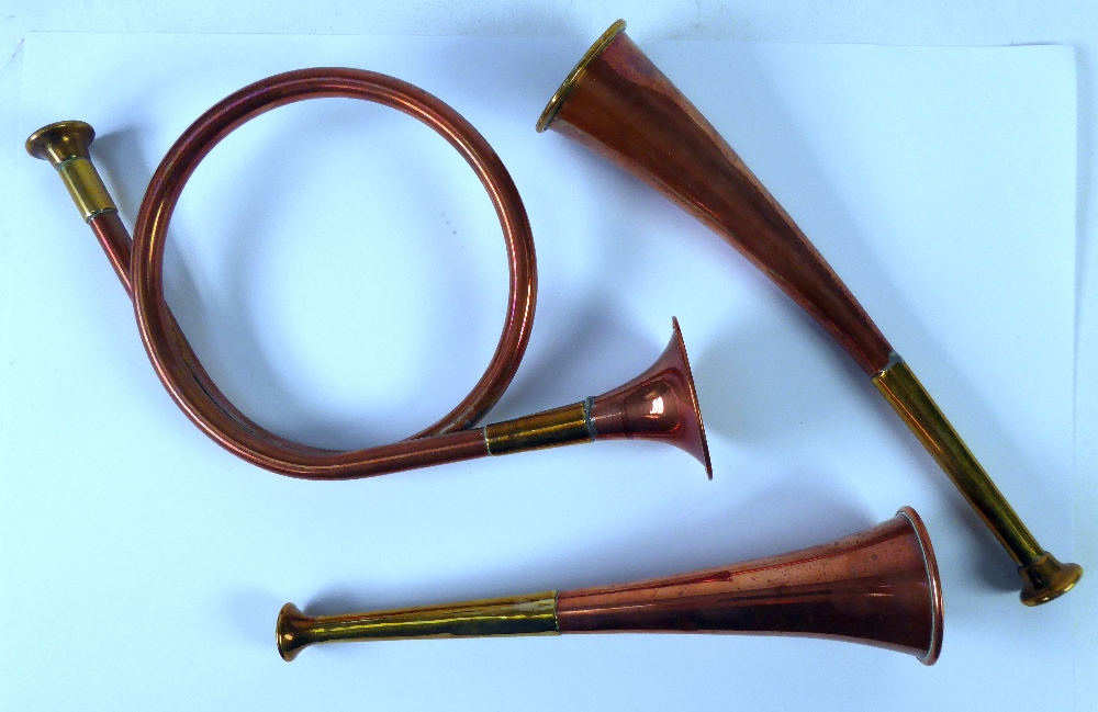 TWO SMALL COPPER AND BRASS HUNTING HORNS, one of curved form and a French horn style ditto (3)