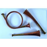 TWO SMALL COPPER AND BRASS HUNTING HORNS, one of curved form and a French horn style ditto (3)