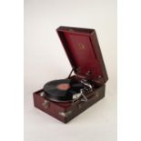 H.M.V. TABLE TOP SPRING DRIVEN GRAMOPHONE, with winding handle and pick up head in maroon fabric