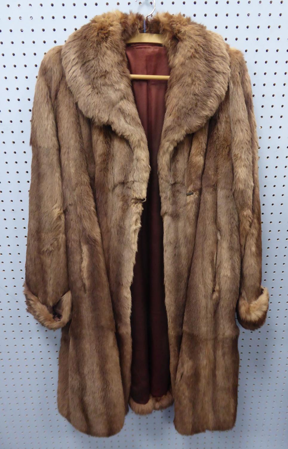A LIGHT BROWN RABBIT LADIES COAT having out turned collar and cuffs, front seem pockets and a DARK