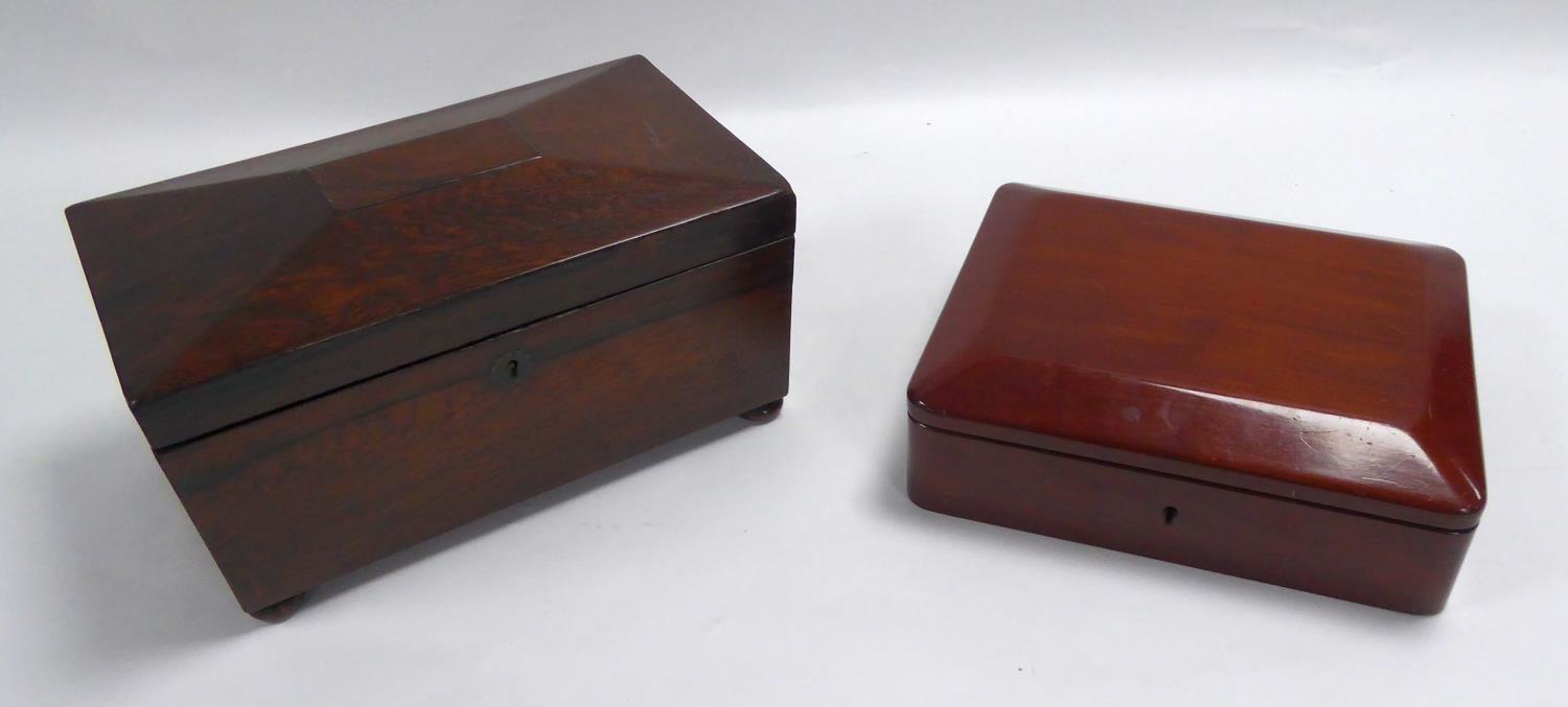 NINETEENTH CENTURY ROSEWOOD TEA CADDY, of sarcophagus form with bun feet, the interior with a pair