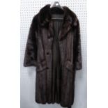 LADY'S LONG, FULL-LENGTH BLACK MINK COAT with broad revered collar, double-breasted with buttons but