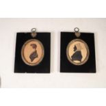 PAIR OF NINETEENTH CENTURY PAINTED OVAL SILHOUETTE MINIATURES OF LADY AND GENTLEMAN, in contemporary