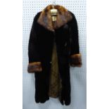 A 3/4 LENGTH LADIES BLACK MUSQUASH COAT with contrast collar and cuffs retailed by Jenners of