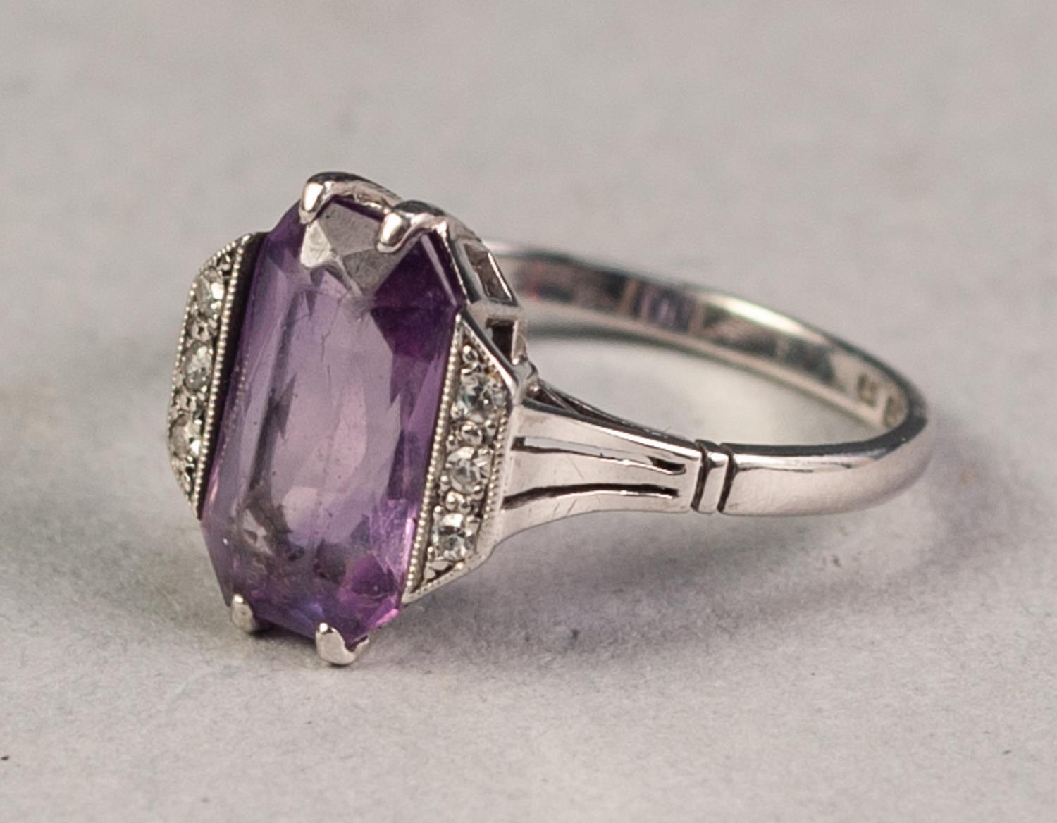 18ct WHITE GOLD AND PLATINUM RING set with oblong amethyst flanked by two rows each of three tiny