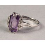 18ct WHITE GOLD AND PLATINUM RING set with oblong amethyst flanked by two rows each of three tiny