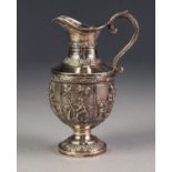 MIDDLE EASTERN EMBOSSED SILVER COLOURED METAL PEDESTAL CREAM JUG, decorated with a central band of