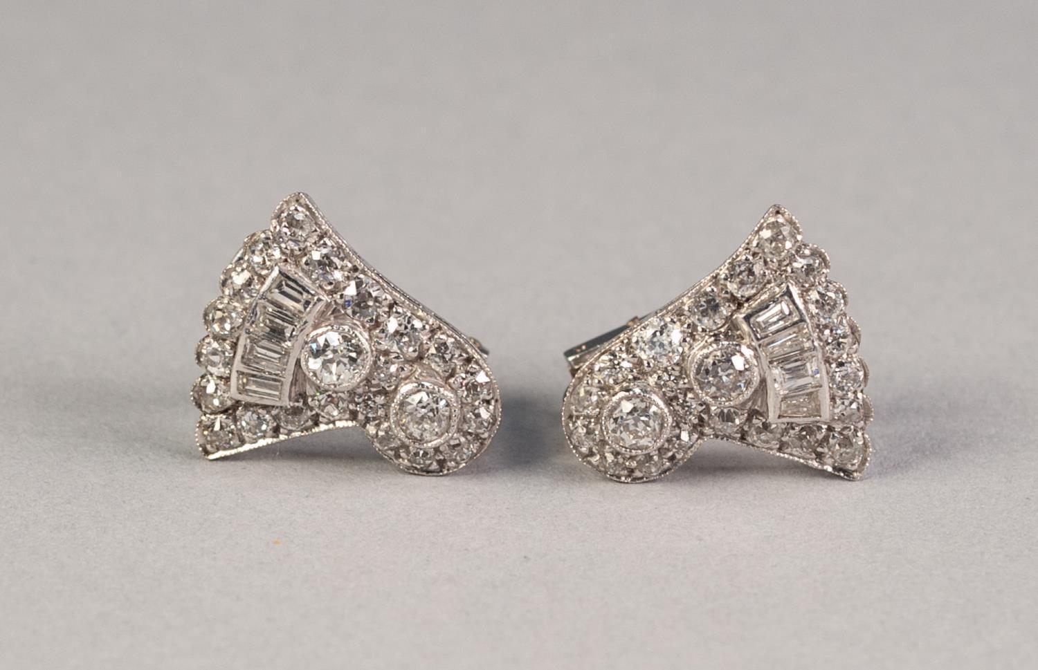 PAIR OF WHITE METAL AND DIAMOND CLIP EARRINGS, in the form of a circular cluster and fan shaped,