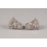 PAIR OF WHITE METAL AND DIAMOND CLIP EARRINGS, in the form of a circular cluster and fan shaped,