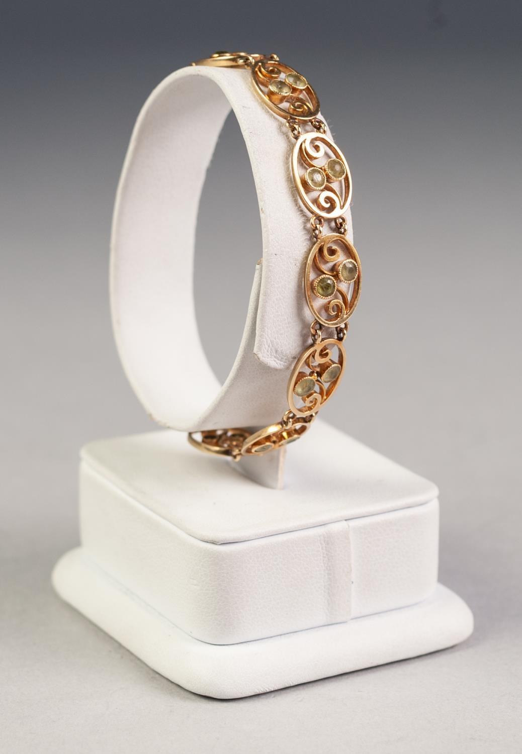 15ct GOLD BRACELET with ten openwork oval links each set with two small peridots and the 15ct GOLD - Image 2 of 2