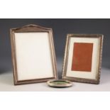 THREE GEORGE V AND LATER SILVER FRONTED PHOTOGRAPH FRAMES WITH EASEL SUPPORTS, comprising: one