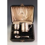 EDWARD VIII CHILDâ€™S ART DECO FOUR PIECE ENGINE SILVER CHRISTENING SET IN CASE, comprising: MUG,