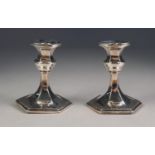 EDWARD VII PAIR OF WEIGHTED SILVER DWARF CANDLESTICKS, each of panelled form with spreading base,